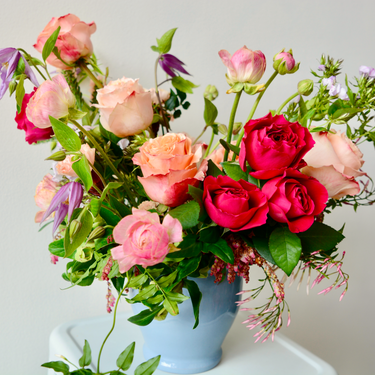 A stunning arrangement in shades of pink, peach, and purple, featuring a variety of fresh blooms. This colorful bouquet is perfect for birthdays, anniversaries, or sympathy occasions, and is available for local delivery in Wake Forest, NC.